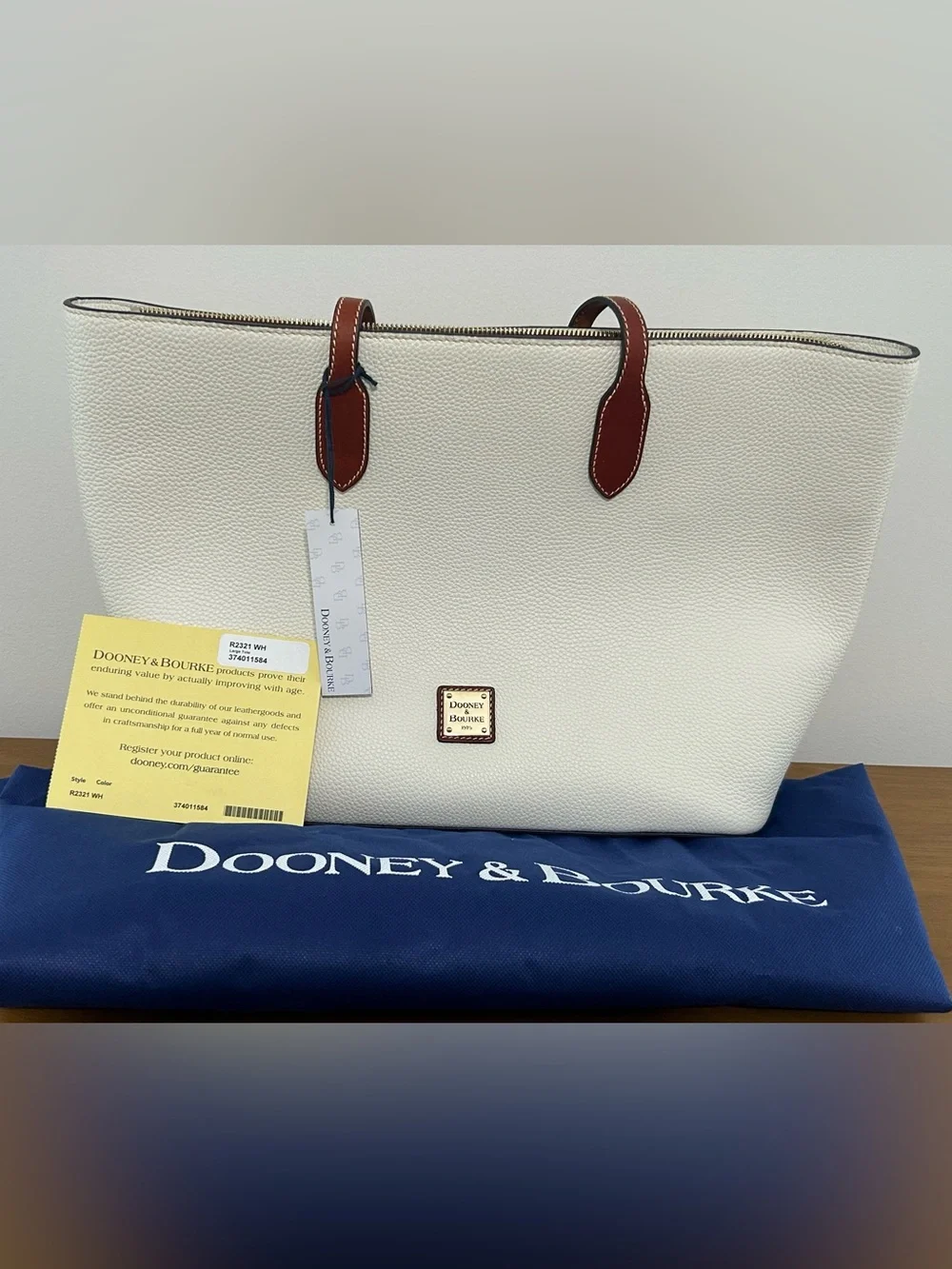 Dooney & Bourke White Pebbled Leather Tote with Brown Trim and Handles